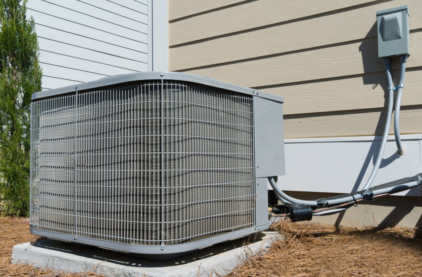 Outdoor central air conditioning unit next to a residential building.