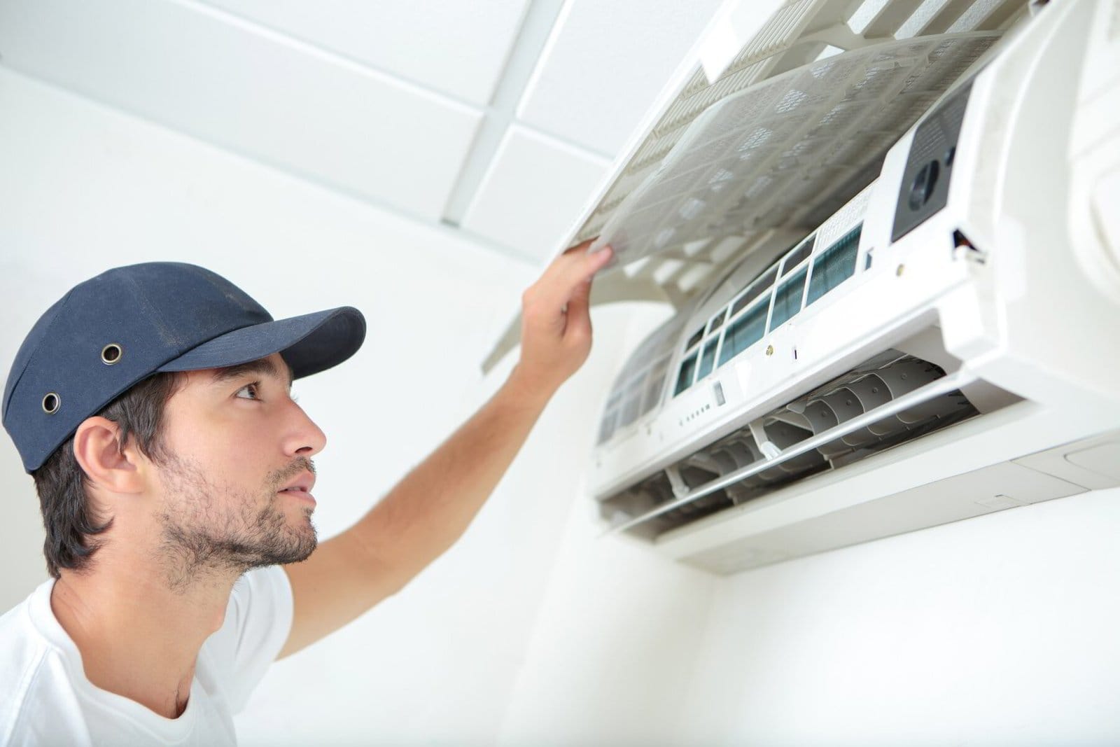 Technician inspecting an air conditioning unit.