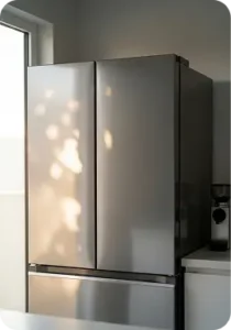 Modern stainless steel refrigerator in bright kitchen setting, emphasizing appliance repair services offered by On Point Service Company.