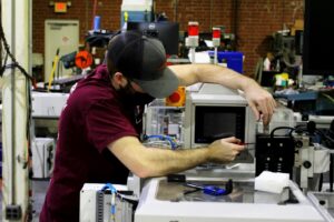 Technician performing appliance repair