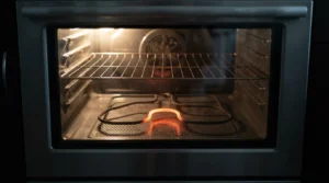 Electric oven bake element glowing unevenly during a heating test.
